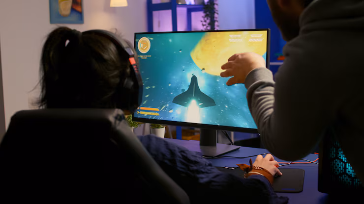 girl playing game on a computer sitting on a gaming chair