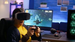 A person wearing a VR headset, holding a game controller, immersed in a space-themed video game on a large monitor in a cozy gaming setup.
