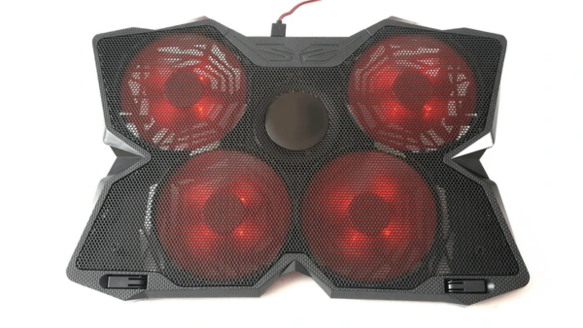 A sleek black cooling pad features four glowing red fans arranged in a circular pattern, with a textured mesh surface for airflow.