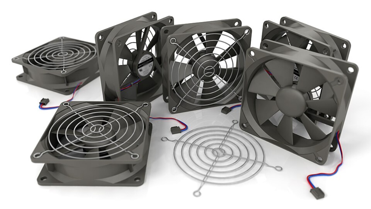 A collection of gray computer cooling fans with wire guards and electrical connections, arranged on a white background.